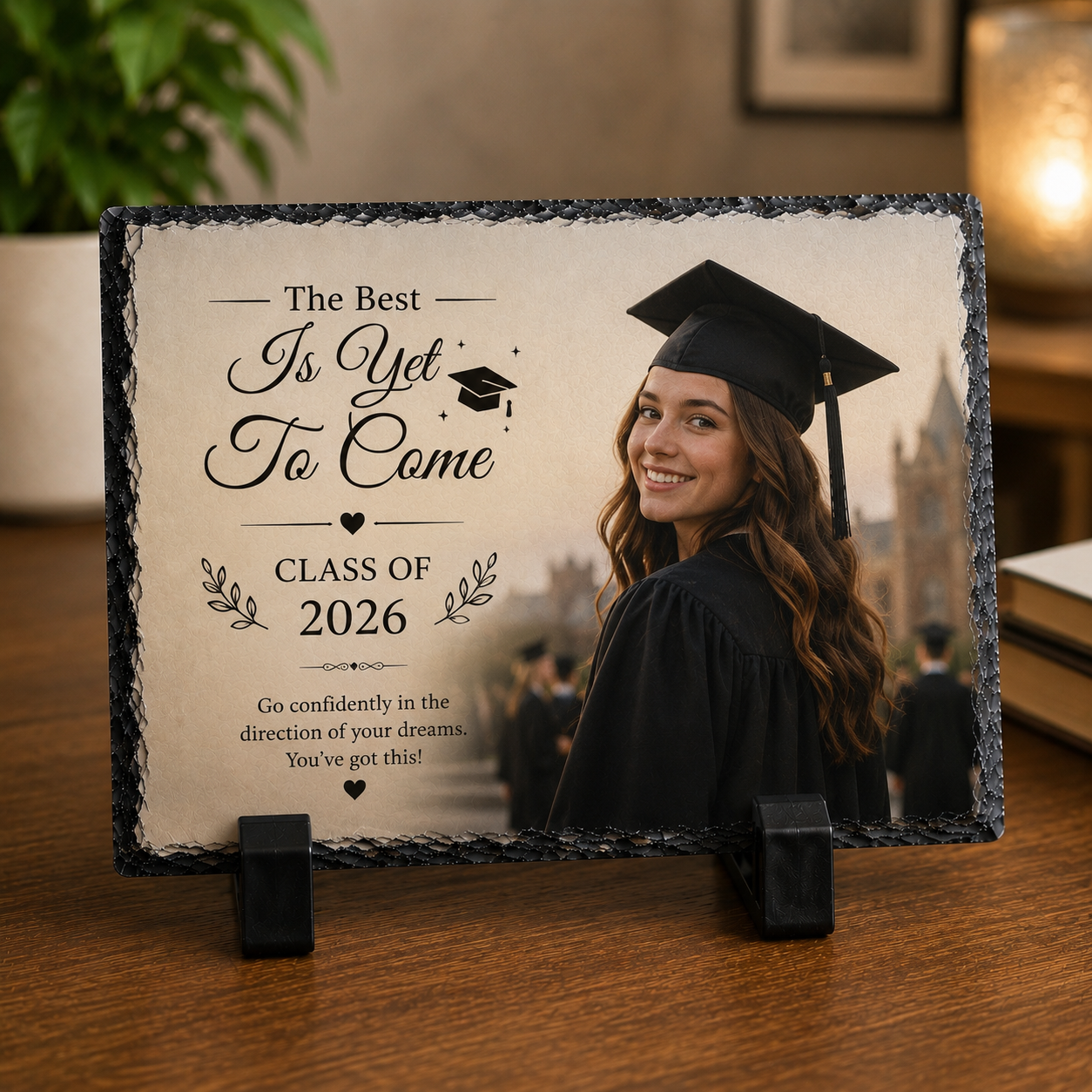 Graduation-themed plaque with a photo of a graduate and motivational text on a wooden surface.