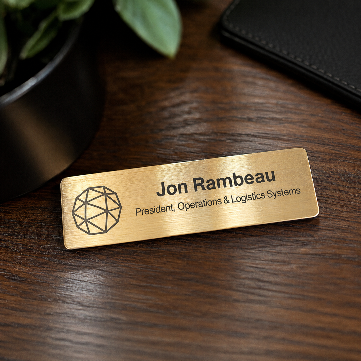A rectangular brushed-metal nameplate