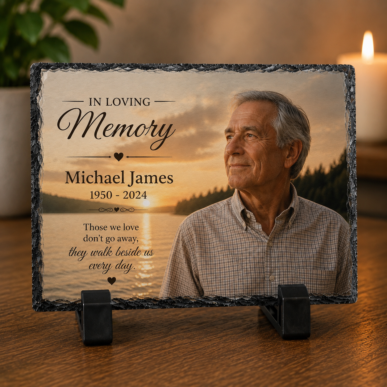 Memorial plaque with a photo of an older man and engraved text on a wooden surface.