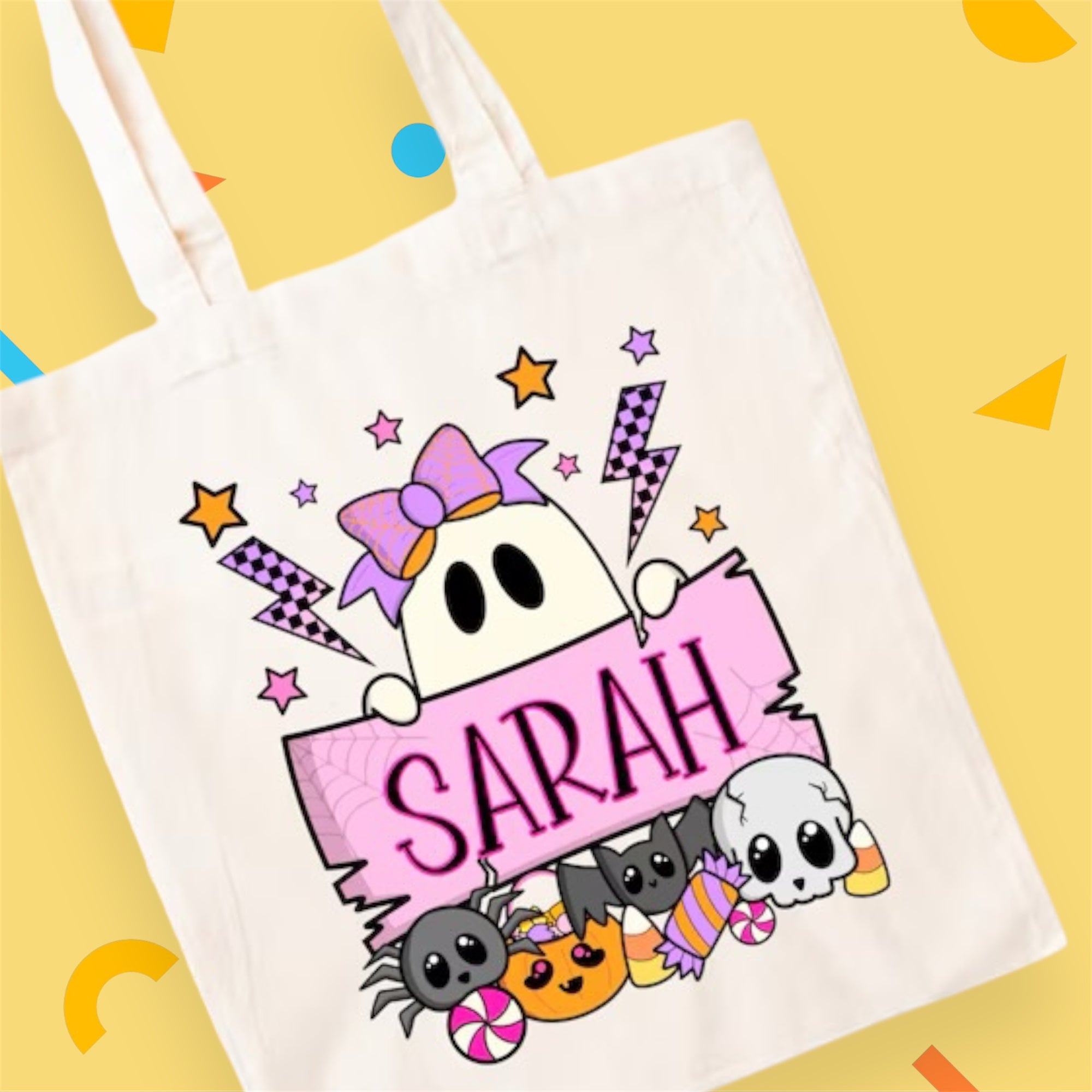 Tote bag with cartoon ghost design and 'SARAH' text on a yellow background